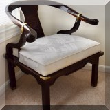 F41. Asian-inspired horseshoe chair with shou medallion on back and brass fittings. 31”h x 31”w x 25”d